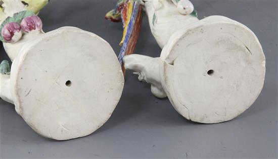 A rare pair of Naples Real Fabbrica porcelain figures of parrots on fruiting branches, early 19th century, height 26.5cm and 27cm, exte